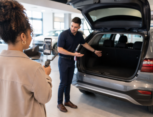Dealership staff filming a vertical short-form vehicle walkaround video